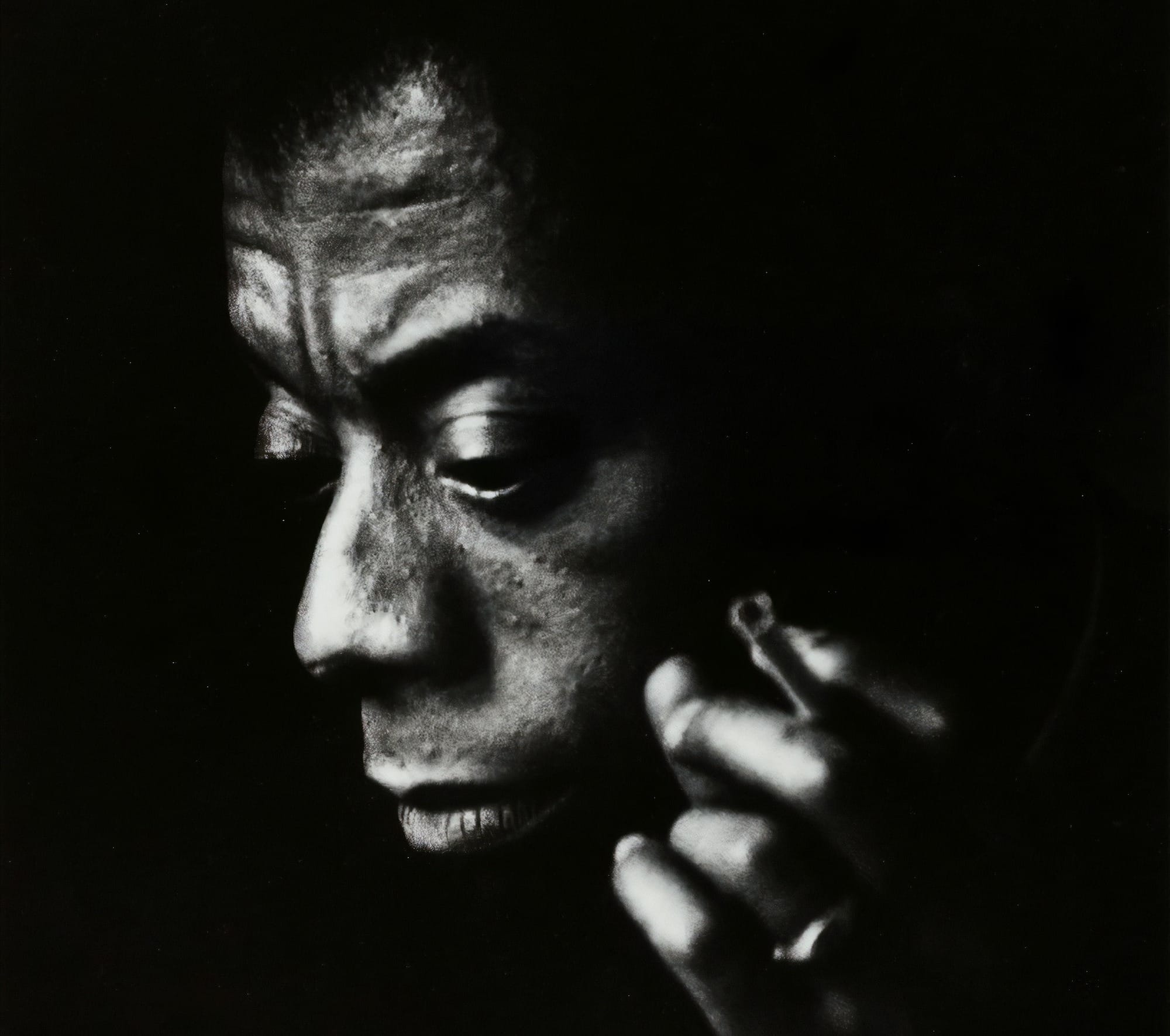 a black and white photo of a man talking on a cell phone